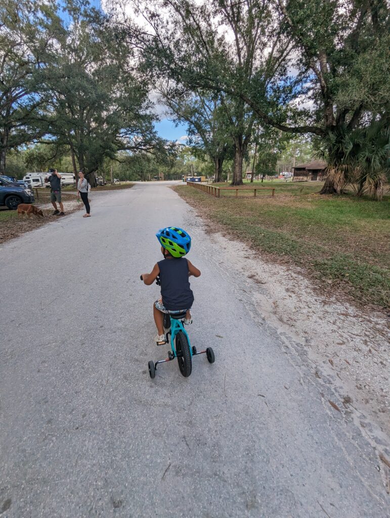 Child riding a bike at campground